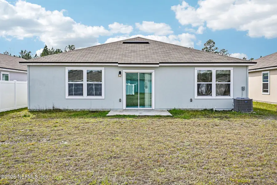 Exterior details and patio area of a home in Cross Creek Express, Green Cove Springs (Image 3).