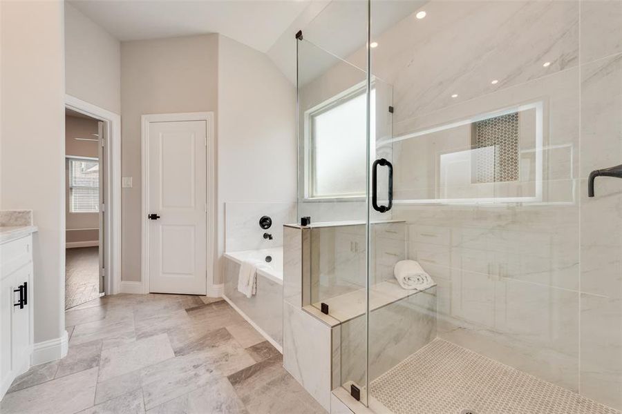 Bathroom featuring a garden tub, a shower stall, vanity, recessed lighting, and vaulted ceiling Bathroom featuring a garden tub, a shower stall, vanity, recessed lighting, and vaulted ceiling