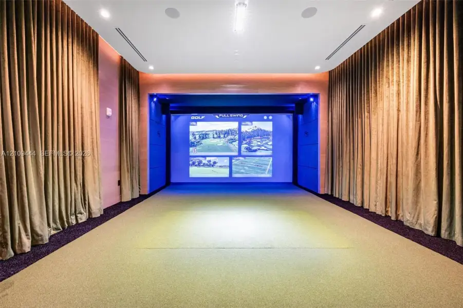 Recreation room featuring an integrated projection system, recessed ceiling lighting, surround sound speakers, and acoustic wall paneling