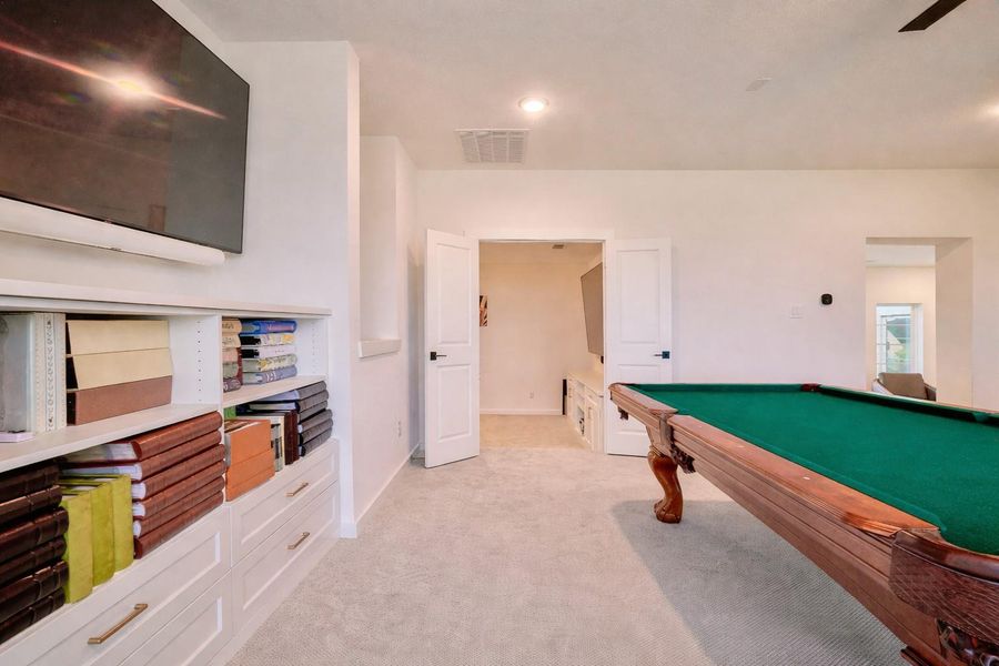 Enjoy movie nights in your private game room and theater, conveniently located by the kitchen stairs.