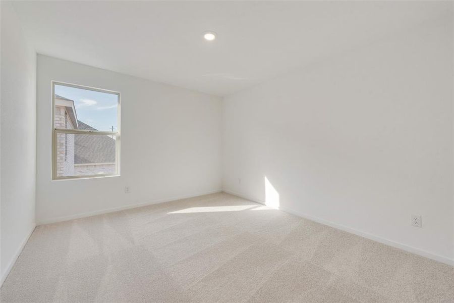 Spare room with light colored carpet