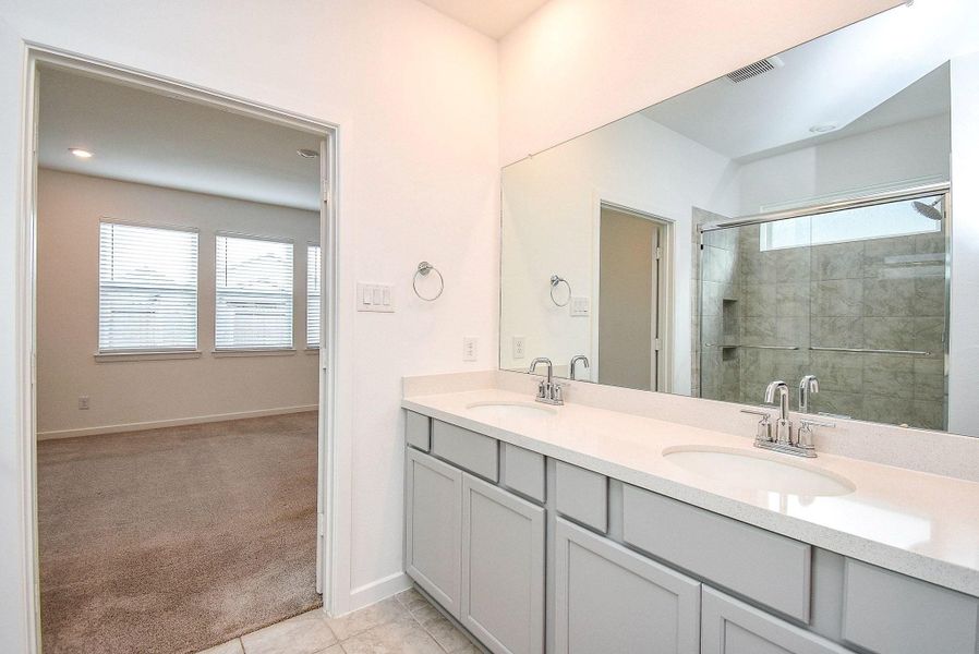PRIMARY BATHROOM WITH DUAL SINKS AND LOTS OF STORAGE