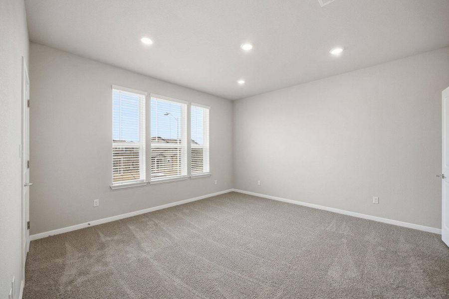 Empty room featuring light colored carpet and recessed lighting