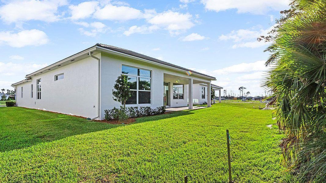Front exterior of a new home in Mosaic, Port St. Lucie, FL, highlighting curb appeal (Image 16).