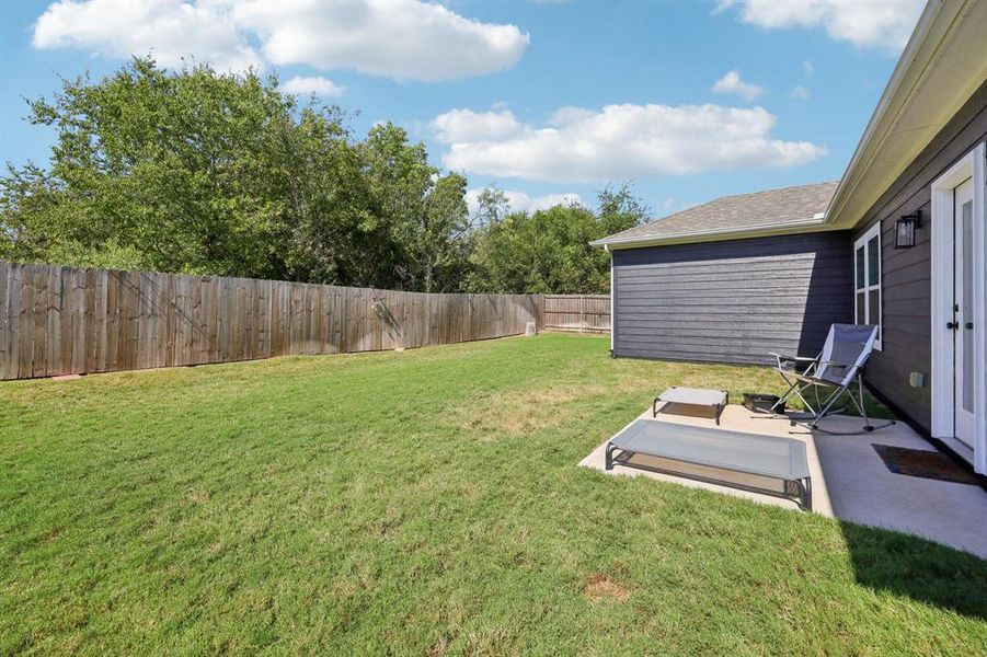 Fenced backyard featuring a patio Fenced backyard featuring a patio