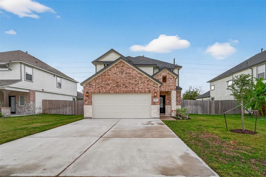 An additional view of the front of the house highlights the private driveway and entryway.