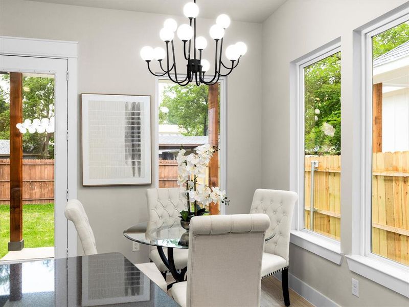 Dining room with healthy amount of natural light and a chandelier
