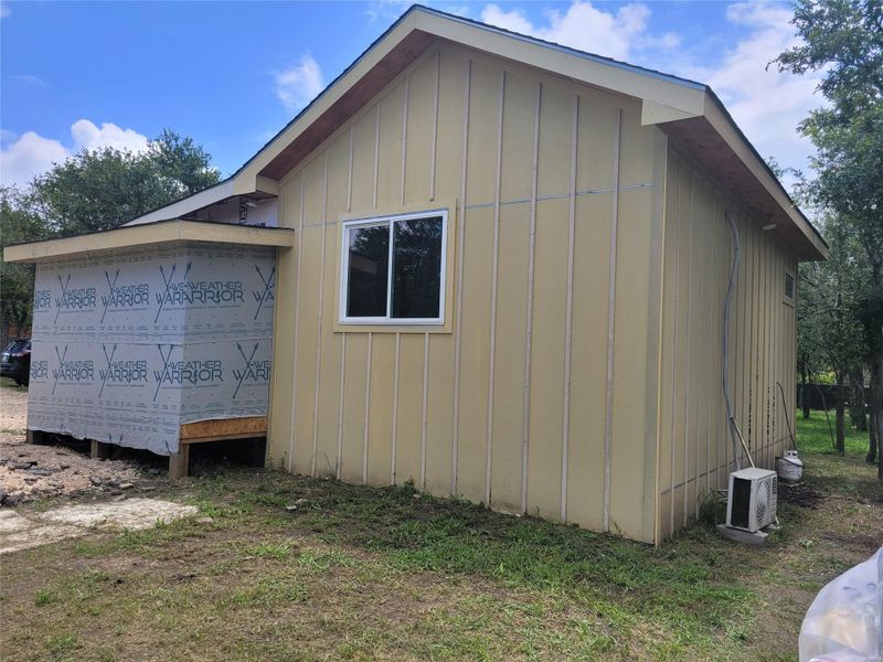 A partially finished exterior with durable siding, offering a glimpse of future potential. A partially finished exterior with durable siding, offering a glimpse of future potential.
