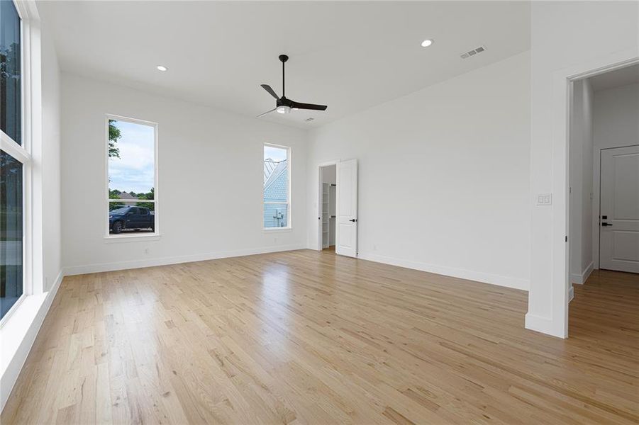 Unfurnished room featuring ceiling fan, light wood-style floors, recessed lighting, and baseboards Unfurnished room featuring ceiling fan, light wood-style floors, recessed lighting, and baseboards
