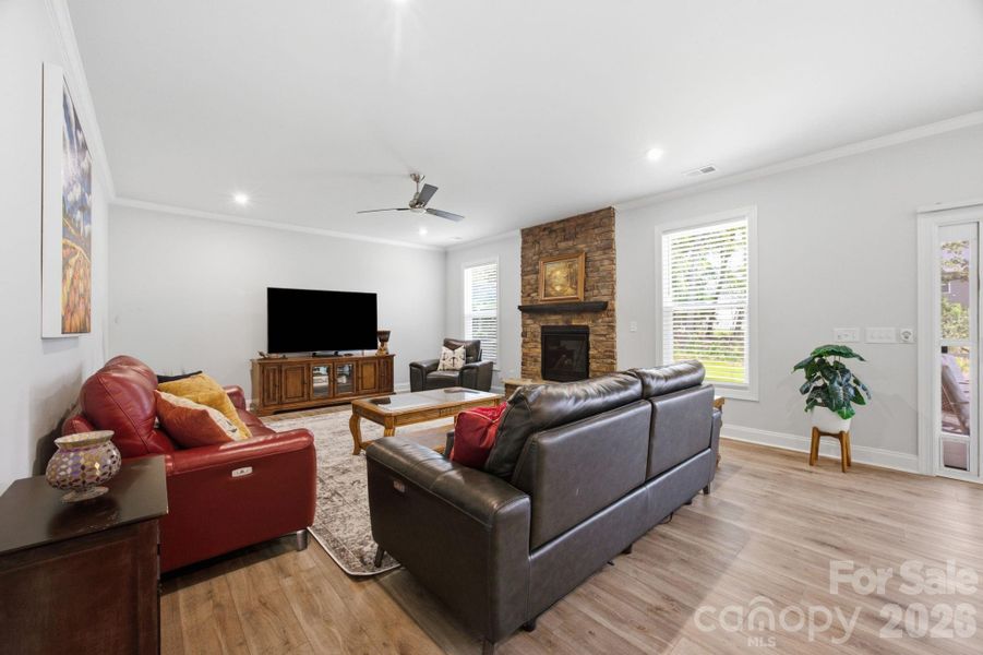 Large living area with gas fireplace and sliding doors out the screened in porch.