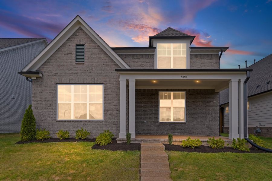 View of front facade with a porch, brick siding, and a yard View of front facade with a porch, brick siding, and a yard