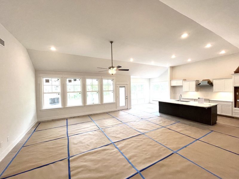 stock photo showing large Great Room with high ceilings and gourmet kitchen under construction. Look at all those windows!