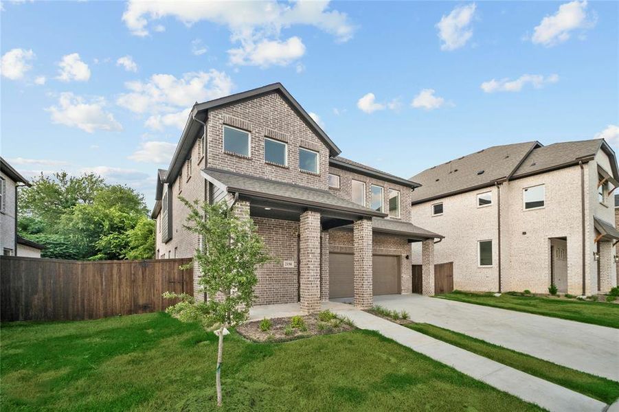 View of front facade with an attached garage, concrete driveway, brick siding, and a shingled roof