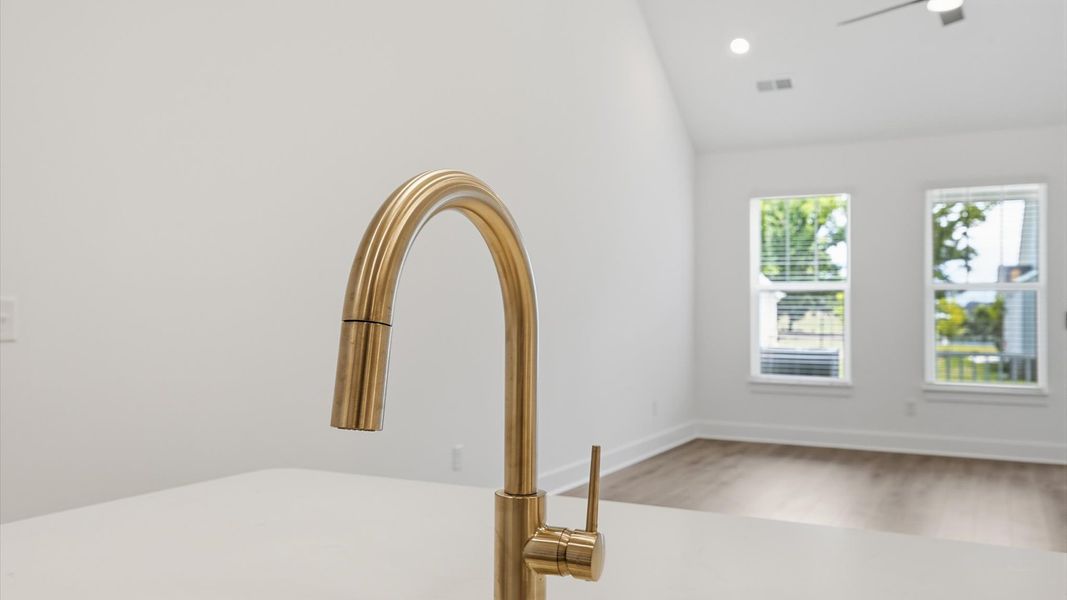 Tasteful kitchen with a center island and stylish hardware—crafted to high standards located at Village at Midway Tasteful kitchen with a center island and stylish hardware—crafted to high standards located at Village at Midway
