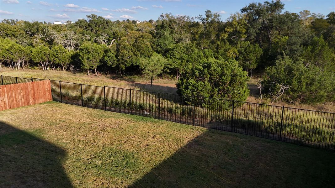 Fenced backyard with a wooded view Fenced backyard with a wooded view