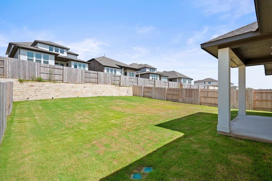 Exterior details and patio area of a home in Lariat, Liberty Hill (Image 24).