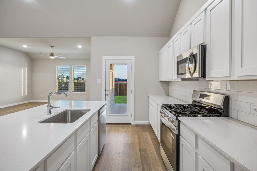 Kitchen in the Wimbledon home plan by Trophy Signature Homes – REPRESENTATIVE PHOTO