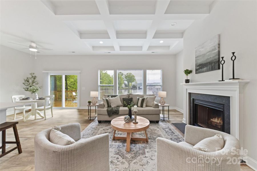 Great Room features wood burning fireplace, coffered ceiling, LVP floors & gorgeous lake views!