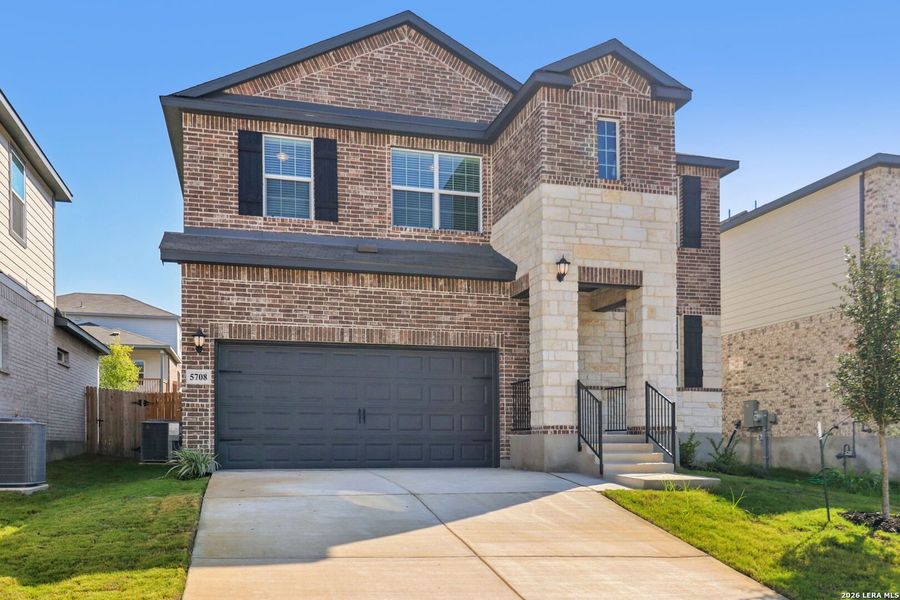 Front exterior of a new home in Thomas Pond, San Antonio, TX, highlighting curb appeal (Image 30).