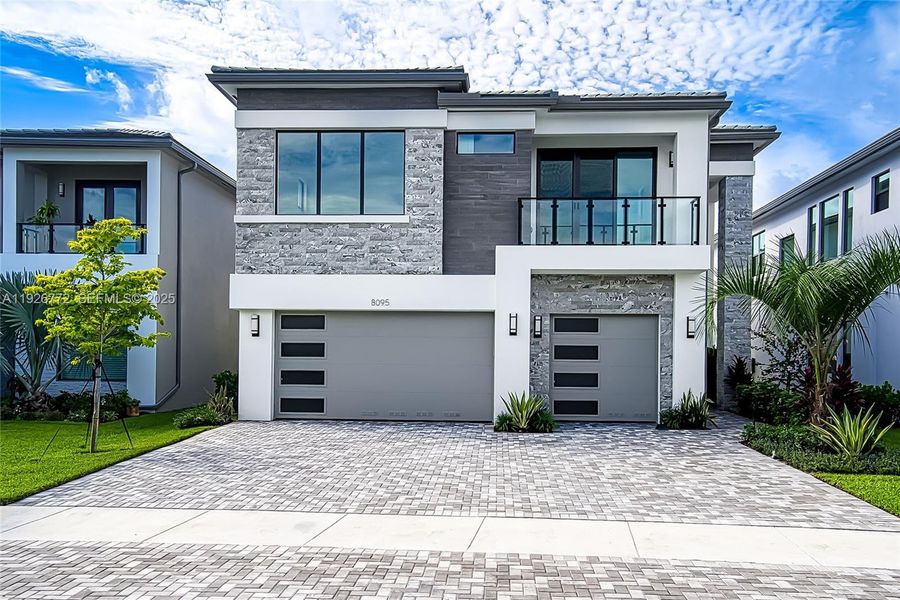 Front exterior of a new home in Lotus Edge, Boca Raton, FL, highlighting curb appeal (Image 1). Front exterior of a new home in Lotus Edge, Boca Raton, FL, highlighting curb appeal (Image 1).