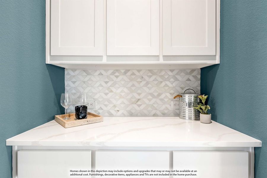 Corner wet bar with white cabinets, marble-look countertop, and geometric tile backsplash against teal walls Corner wet bar with white cabinets, marble-look countertop, and geometric tile backsplash against teal walls