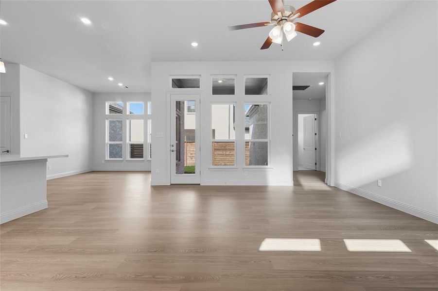 Unfurnished living room featuring light wood-style floors, recessed lighting, and ceiling fan