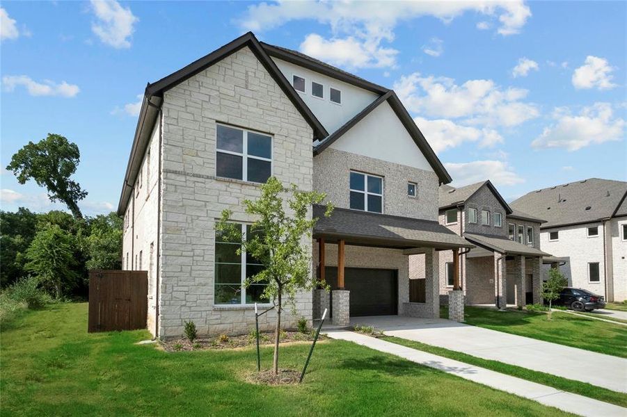View of front of home featuring stone siding, an attached garage, a front lawn, and driveway View of front of home featuring stone siding, an attached garage, a front lawn, and driveway