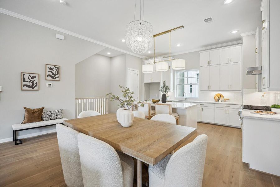 Kitchen and dining area - Kitchen offers honed Carrera seating island and double sided island storage.