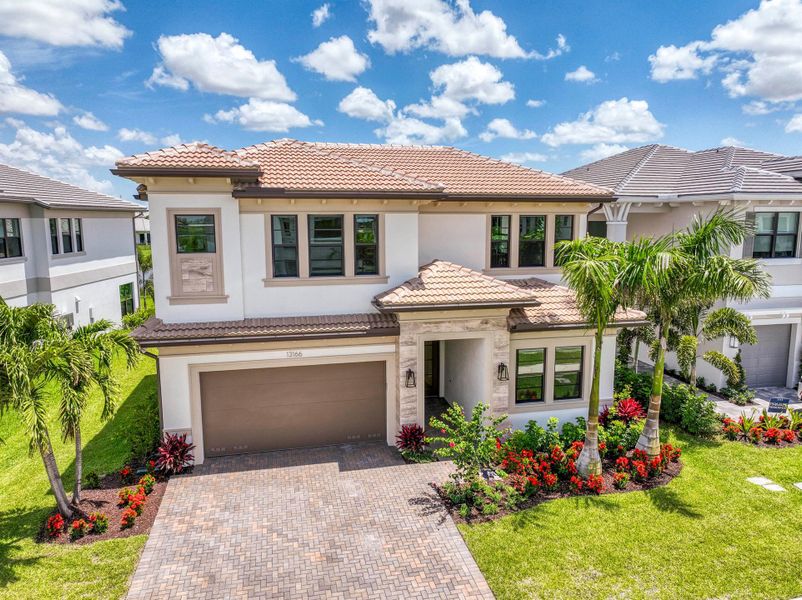 Front exterior of a new home in Apex at Avenir, Palm Beach Gardens, FL, highlighting curb appeal (Image 21).