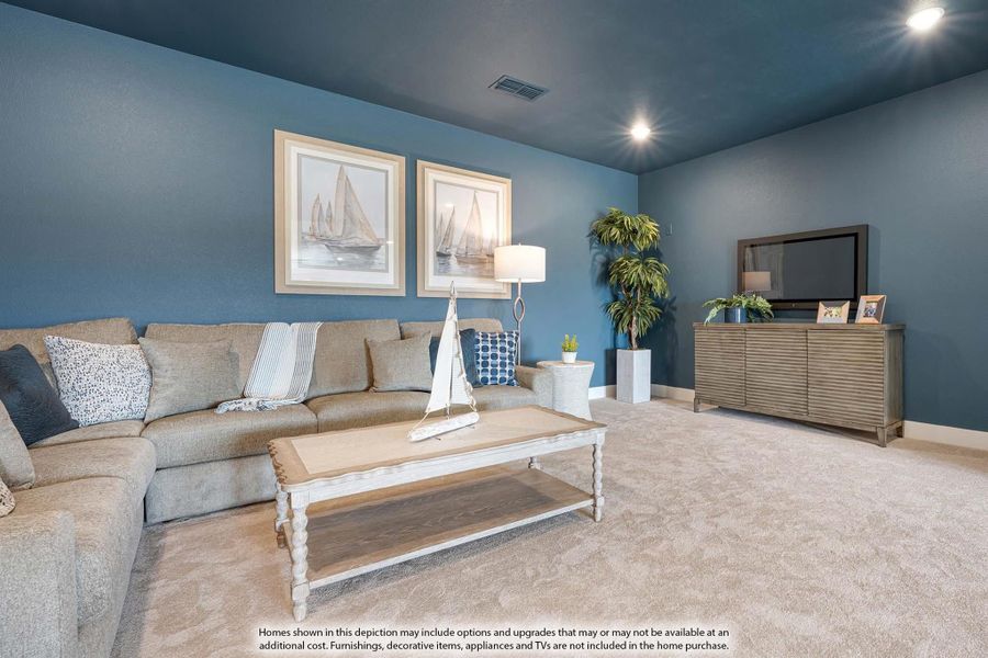Living room with blue walls, sectional sofa, coffee table, and TV console on carpet flooring