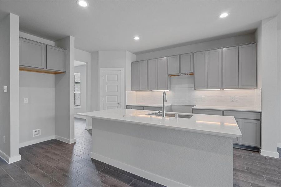 This kitchen is by far any chef’s dream! This spacious kitchen features high ceilings, light stained wood cabinets, quartz countertops, SS appliances, modern tile backsplash, recessed lighting, extended counter space for breakfast bar, and a walk-in pantry all overlooking your huge family room.