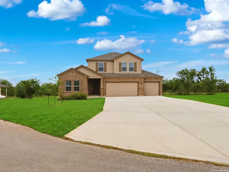 Front exterior of a new home in Chaparral Ranch, Floresville, TX, highlighting curb appeal (Image 1). Front exterior of a new home in Chaparral Ranch, Floresville, TX, highlighting curb appeal (Image 1).
