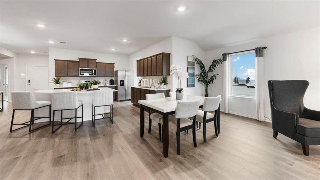 Open-concept living space featuring wood-finish flooring throughout Open-concept living space featuring wood-finish flooring throughout