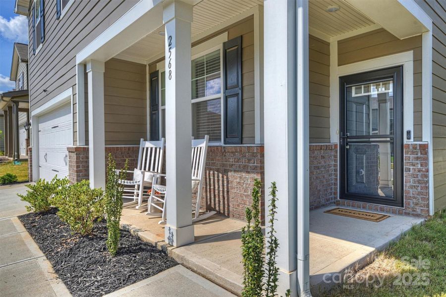 Relax on the front porch and greet the neighbors as they stroll by.