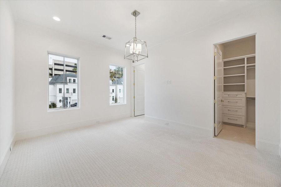 The final second-floor bedrooms features Shaw carpet in the color pearl, en-suite bathroom, spaciouswalk-in closet.