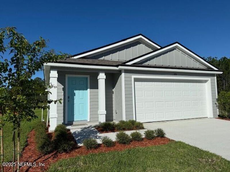 Front exterior of a new home in Grand Reserve, Bunnell, FL, highlighting curb appeal (Image 27).