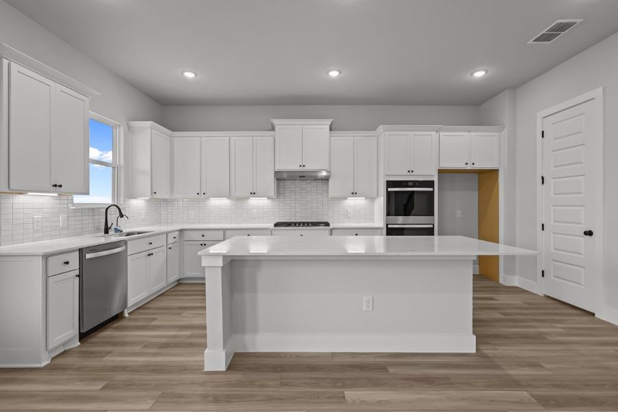A kitchen with white cabinets. A kitchen with white cabinets.