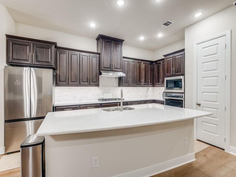 Additional view of island and kitchen area. Room for stools or other seating around the island.
