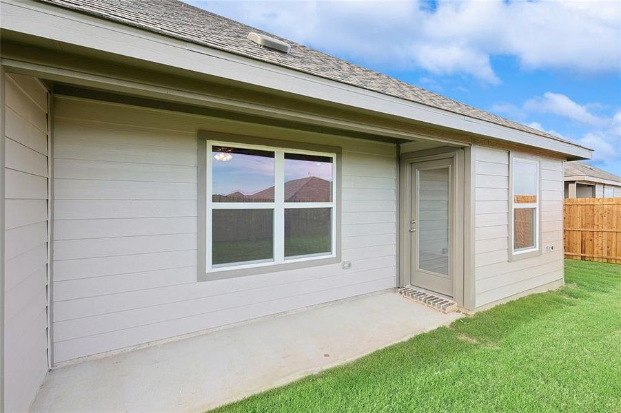 Entrance to property with a lawn