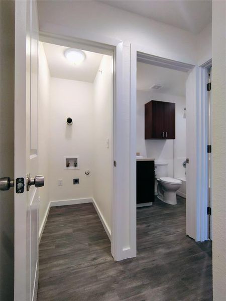 Clothes washing area featuring gas dryer hookup, hookup for a washing machine, and dark hardwood / wood-style floors