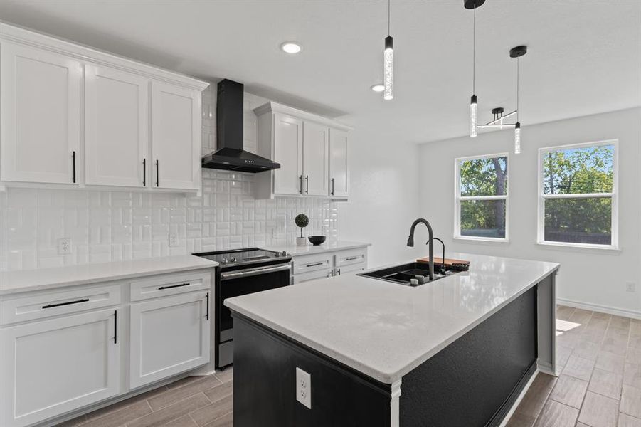 Kitchen with electric stove, decorative backsplash, and white cabinets