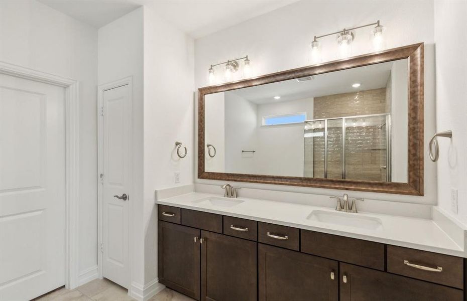 Elegant owner's bathroom with dual vanity *real home pictured