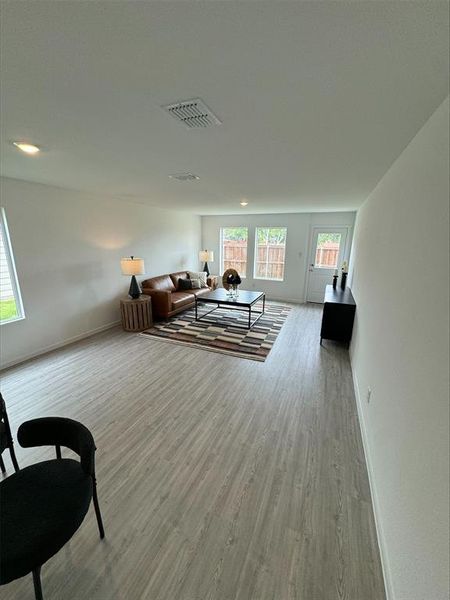 Living room with hardwood / wood-style flooring