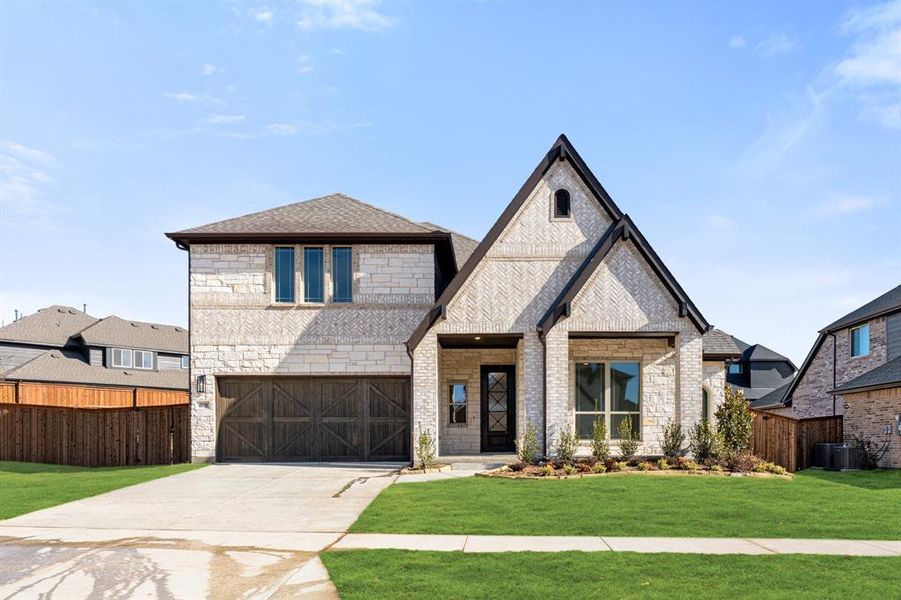 Front exterior of a new home in Windsong Ranch, Prosper, TX, highlighting curb appeal (Image 2).