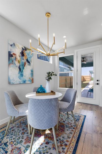 Dining area with hardwood / wood-style flooring and a chandelier