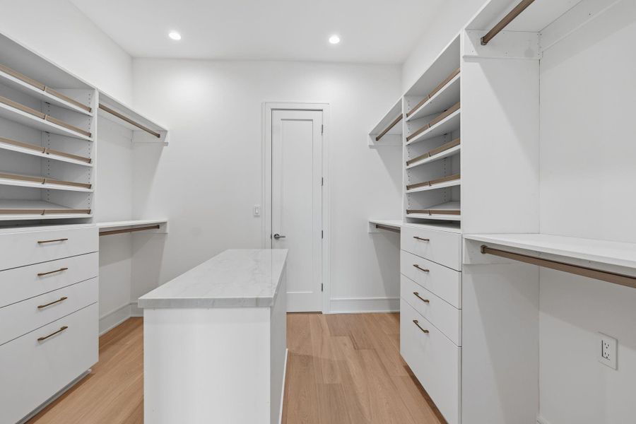 Primary closet with direct access to utility room.