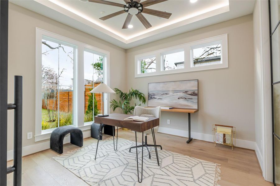 Home office featuring light wood-style flooring, a ceiling fan, and recessed lighting