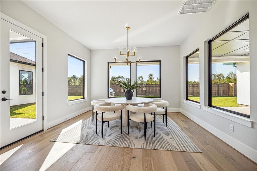 Breakfast room with windows on three sides, and a door to one of the covered patios. The gameroom is adjacent to this space.