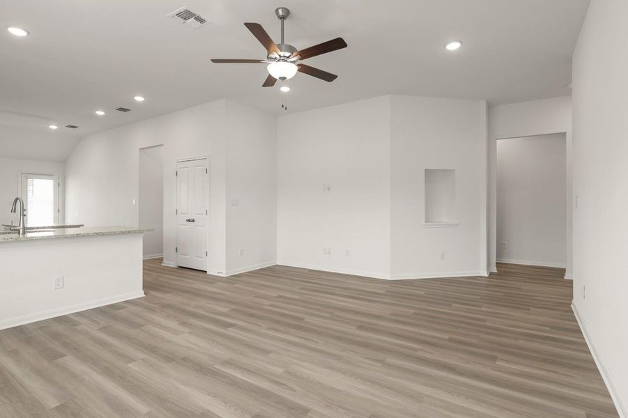 Unfurnished living room with recessed lighting, a ceiling fan, light wood-style floors, and vaulted ceiling