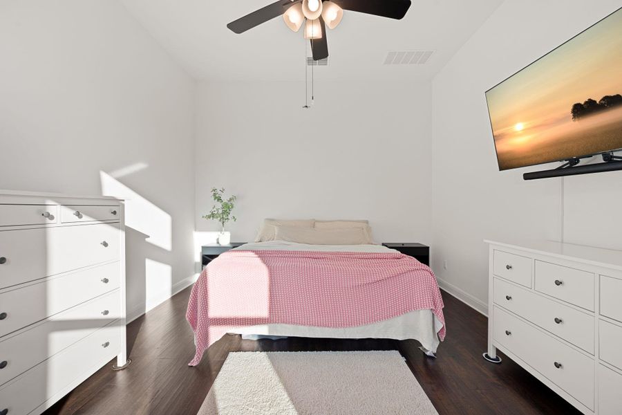 Rich hard surfaced floors complement this cozy bedroom, creating a peaceful retreat. Rich hard surfaced floors complement this cozy bedroom, creating a peaceful retreat.